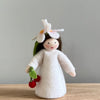 A felt Cherry Flower Fairy wearing a white dress and cherry flower on her head with light skin tone holding a pair of cherries | © Conscious Craft